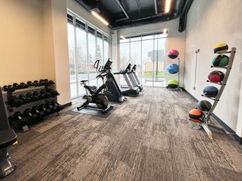 a gym with cardio machines and weights on the floor at The Duo, University Place, 98466